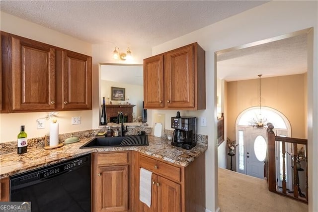 kitchen featuring dishwasher, an inviting chandelier, sink, a textured ceiling, and decorative light fixtures