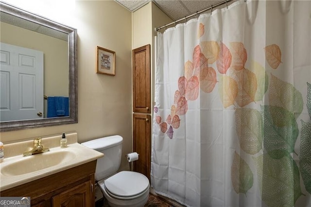 bathroom featuring curtained shower, vanity, and toilet