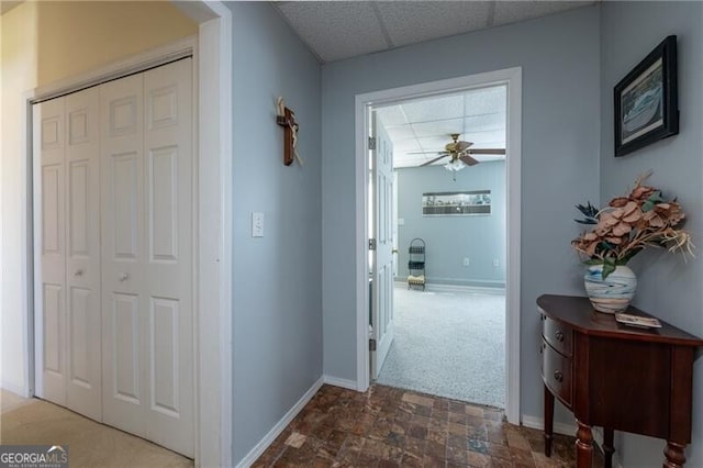 corridor featuring dark colored carpet