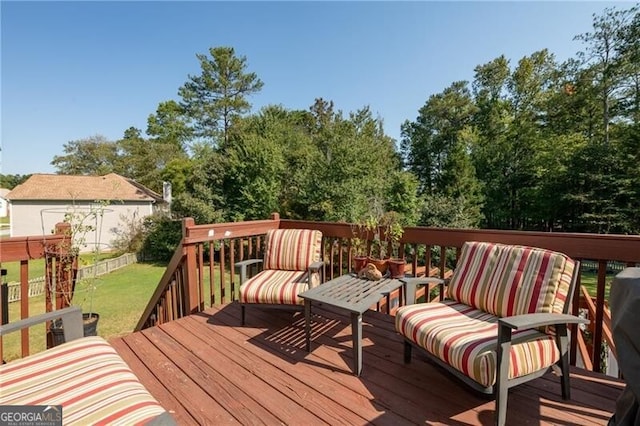 wooden deck with a lawn and an outdoor hangout area