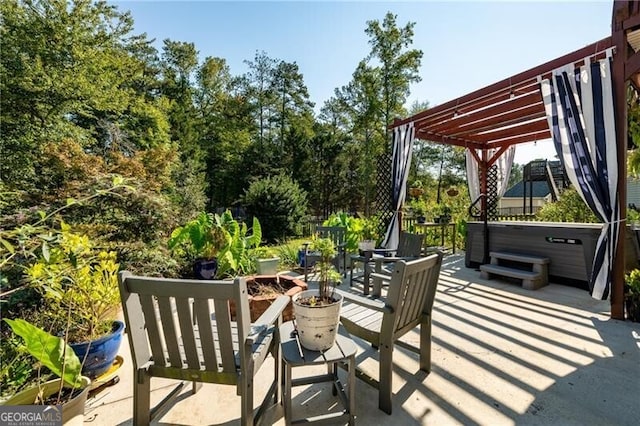 view of patio / terrace with a pergola and a hot tub