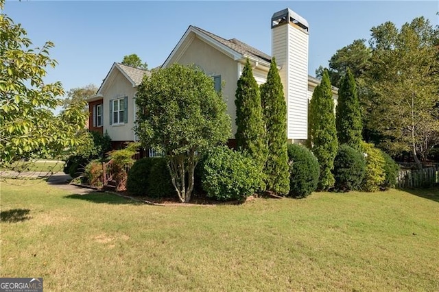 view of side of home featuring a lawn