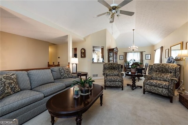 living room with ceiling fan with notable chandelier, carpet, and lofted ceiling