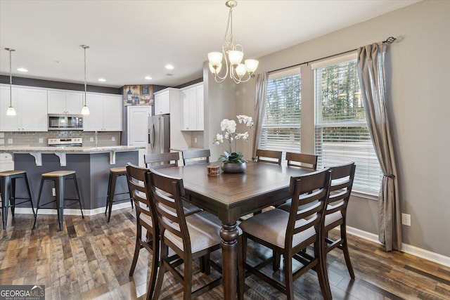 dining space with a chandelier, dark hardwood / wood-style floors, and a wealth of natural light