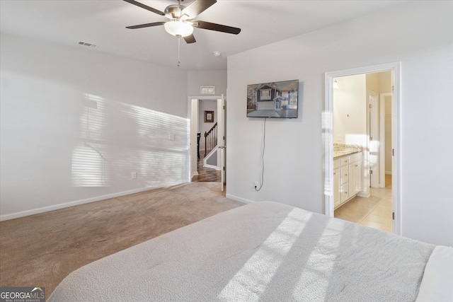 carpeted bedroom with connected bathroom and ceiling fan