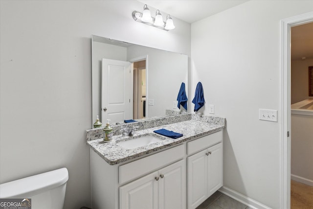 bathroom featuring tile patterned floors, vanity, and toilet