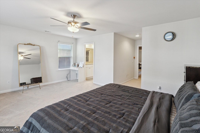 carpeted bedroom with ceiling fan and ensuite bathroom