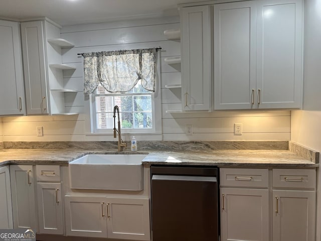 kitchen featuring dishwasher, light stone countertops, sink, and white cabinets