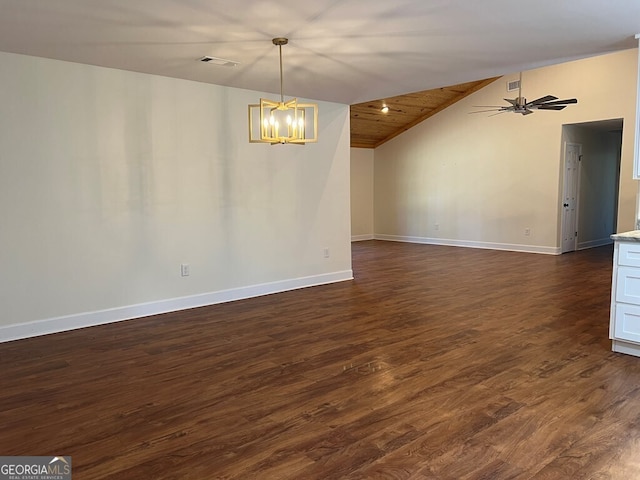 spare room featuring ceiling fan with notable chandelier, dark hardwood / wood-style flooring, vaulted ceiling, and wooden ceiling