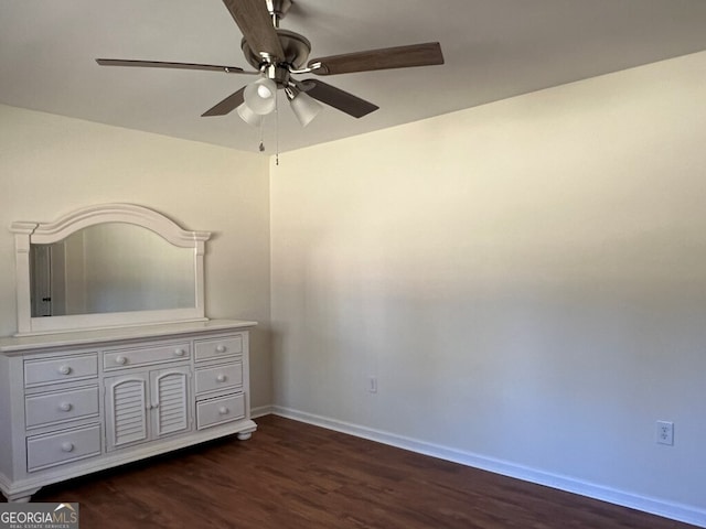 unfurnished bedroom with ceiling fan and dark wood-type flooring