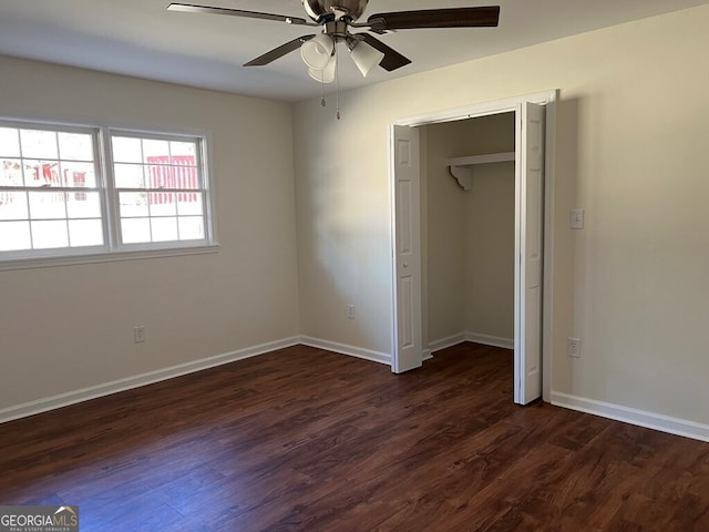 unfurnished bedroom featuring a closet, dark hardwood / wood-style floors, and ceiling fan