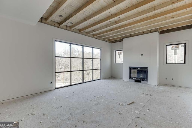 unfurnished living room featuring heating unit, beamed ceiling, and wooden ceiling