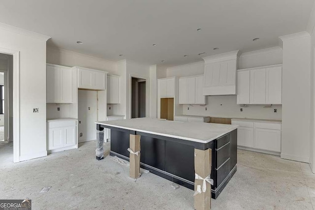 kitchen featuring white cabinetry, a spacious island, and custom exhaust hood