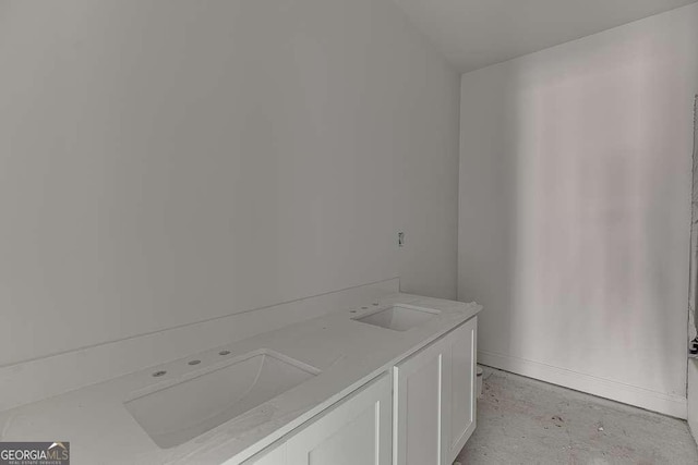 bathroom featuring sink and concrete flooring