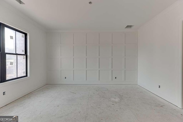 unfurnished room featuring a healthy amount of sunlight and ornamental molding