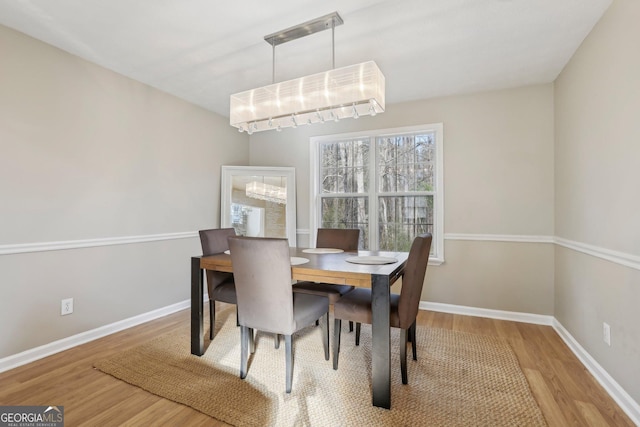 dining area featuring a chandelier and hardwood / wood-style floors