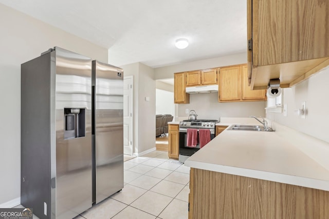 kitchen with light tile patterned floors, light brown cabinets, stainless steel appliances, and sink