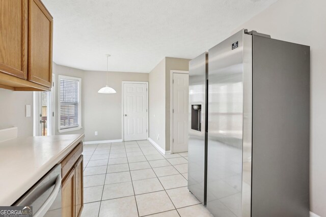 kitchen with stainless steel fridge with ice dispenser, dishwasher, light tile patterned floors, and pendant lighting