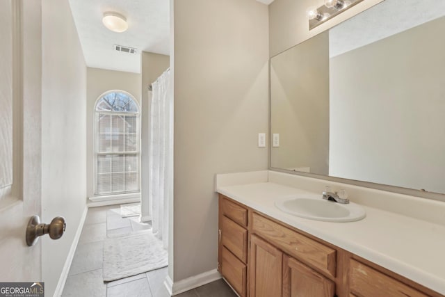 bathroom featuring tile patterned flooring and vanity