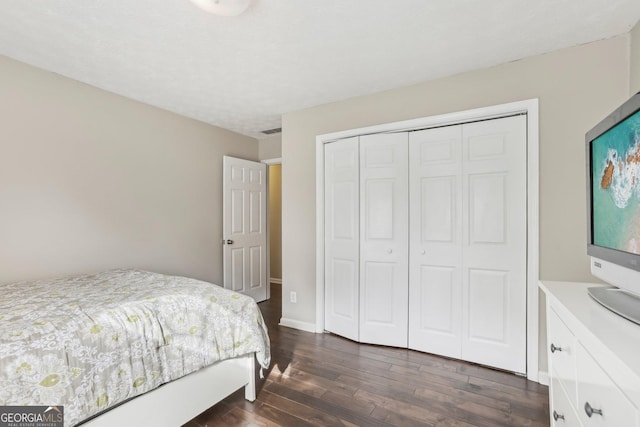 bedroom featuring dark hardwood / wood-style flooring and a closet