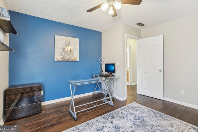 office area featuring a textured ceiling, ceiling fan, and dark wood-type flooring