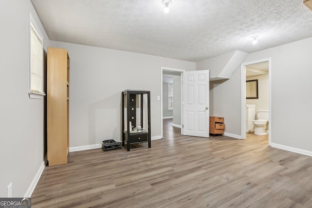 interior space with hardwood / wood-style floors and a textured ceiling