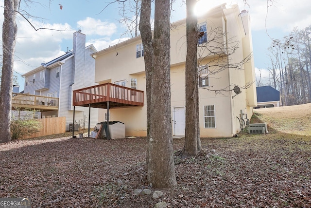 back of property featuring a wooden deck