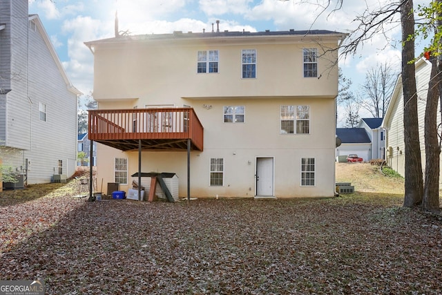 back of house featuring a deck and central AC