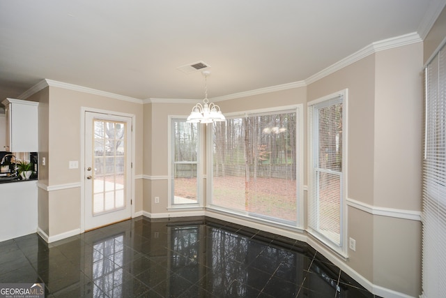 unfurnished dining area featuring plenty of natural light, crown molding, and a notable chandelier