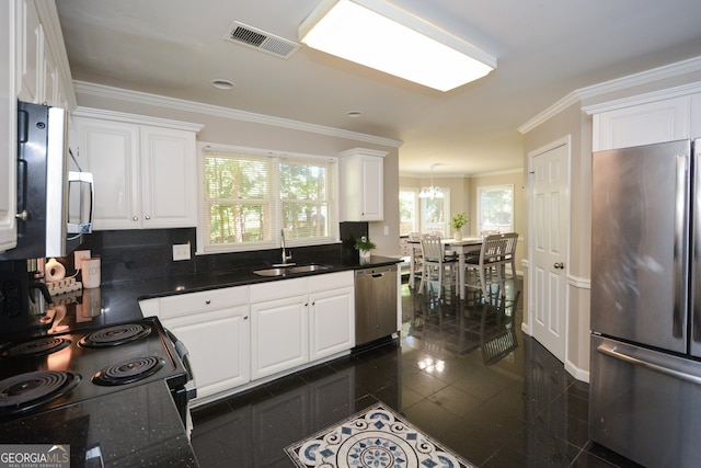 kitchen featuring crown molding, white cabinetry, sink, and stainless steel appliances