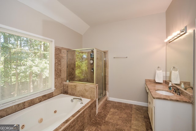 bathroom featuring vanity, separate shower and tub, and vaulted ceiling