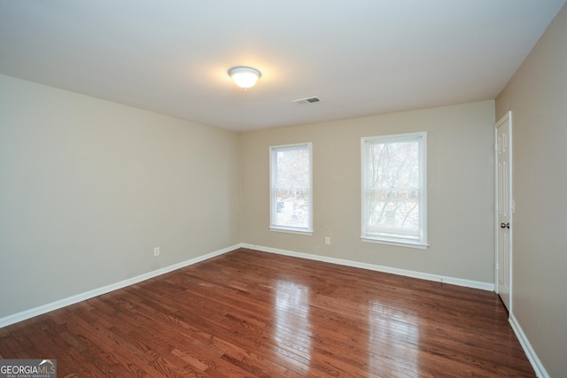 spare room featuring dark hardwood / wood-style flooring