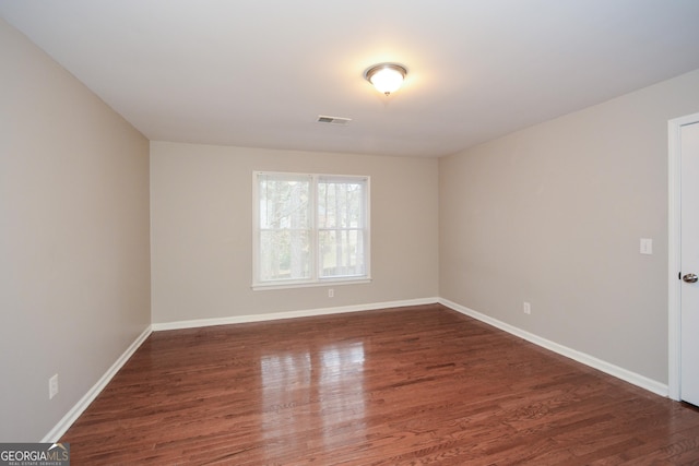 empty room featuring dark hardwood / wood-style flooring