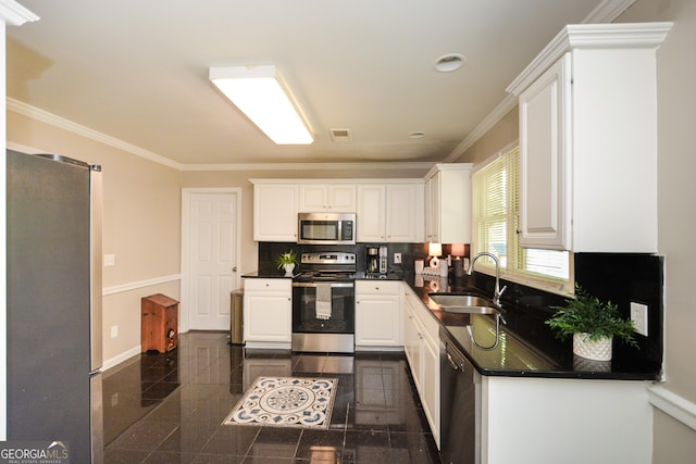 kitchen featuring sink, white cabinetry, stainless steel appliances, and ornamental molding