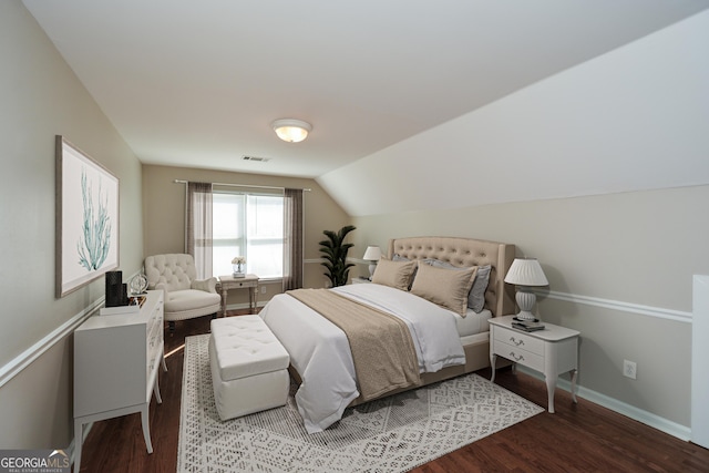 bedroom with lofted ceiling and wood-type flooring