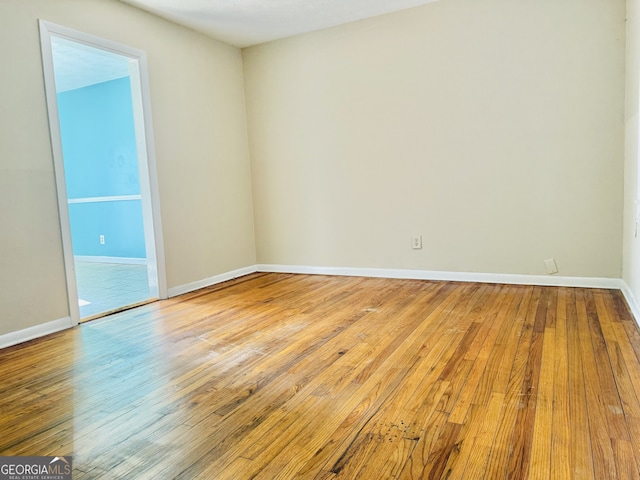 unfurnished room with wood-type flooring