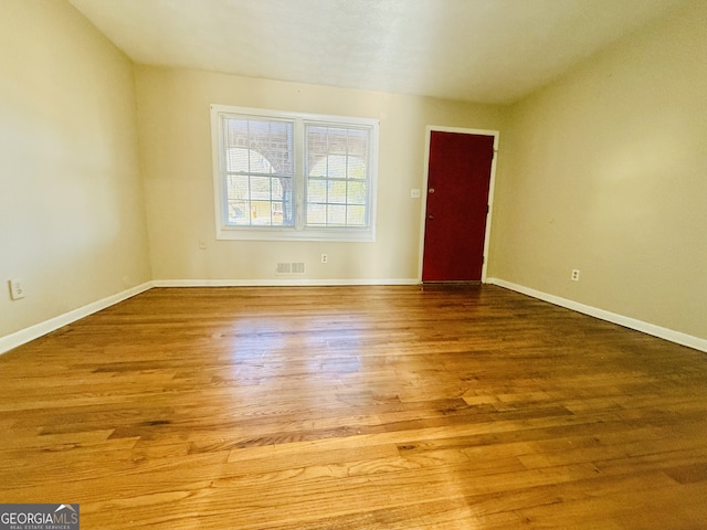 unfurnished room featuring wood-type flooring