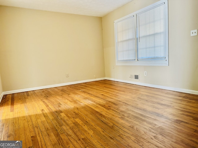 unfurnished room with light wood-type flooring