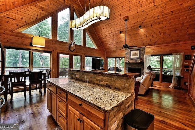 kitchen with dark hardwood / wood-style flooring, high vaulted ceiling, wood ceiling, and light stone counters