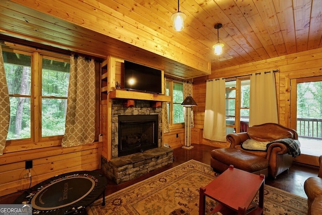 living room with wood walls, a fireplace, wood ceiling, and hardwood / wood-style flooring