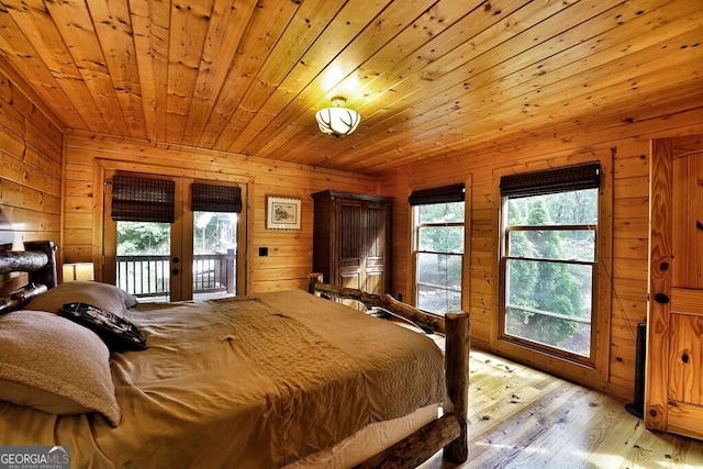 bedroom with french doors, light wood-type flooring, wood ceiling, access to outside, and wood walls