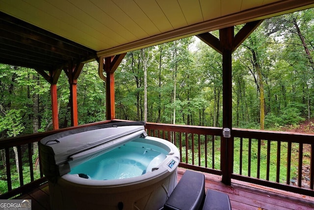 wooden terrace featuring a hot tub