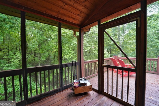 unfurnished sunroom with wooden ceiling and vaulted ceiling