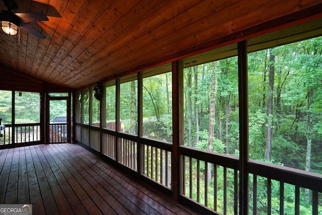 unfurnished sunroom with ceiling fan, wood ceiling, and lofted ceiling