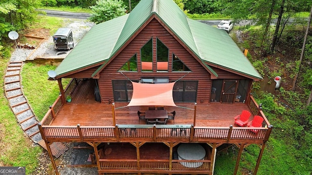 back of house featuring central AC unit and a deck