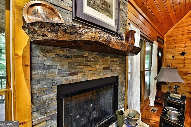 details with wood walls and a stone fireplace