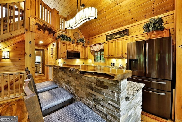 kitchen with decorative light fixtures, wood ceiling, stainless steel refrigerator with ice dispenser, and a wealth of natural light