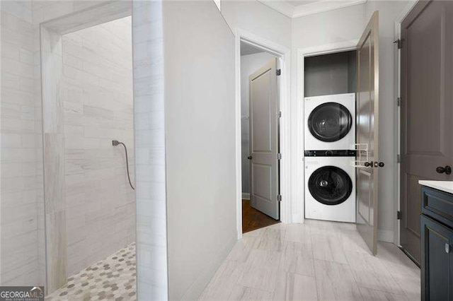 laundry area featuring stacked washer / dryer