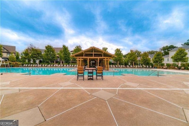 view of swimming pool with a patio