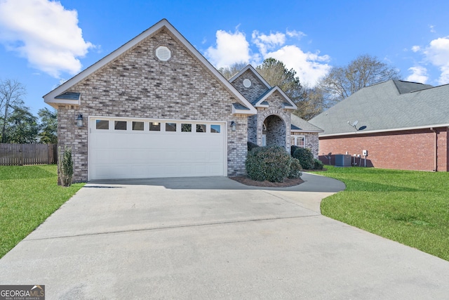 view of front of home with a front yard and a garage